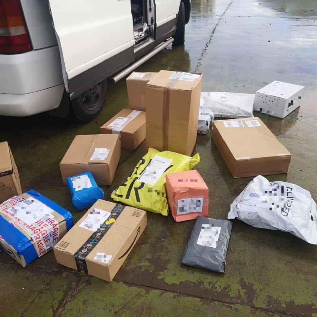 A bunch of parcels strewn across the street in a mess