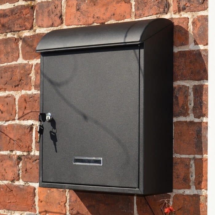 An iLoveParcels letter box mounted on a brick wall