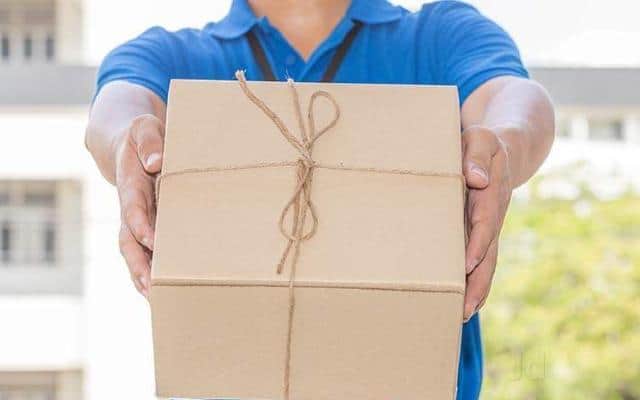 A delivery man handing over a parcel